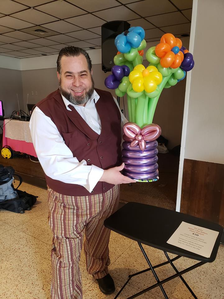 Mother's Day Delivery of Balloon Flower Bouquet is being held by Appleton Magician and Balloon artist, The Amazing Zoomalata